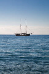 Fototapeta premium Wooden boat with two masts at anchor