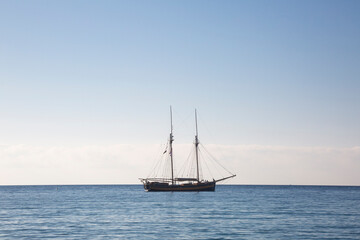 Wooden boat with two masts at anchor