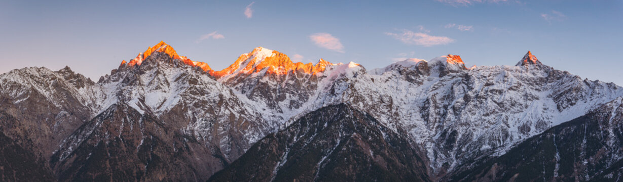 Panoramic view during sunset over snow cladded Kinner kailash mountain peaks falls in Greater Himalayas mountain range from Kalpa village, Kinnaur, Himachal Pradesh, India.