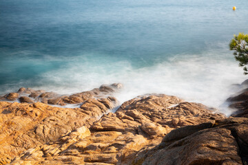 the sea crashing against the rocks
