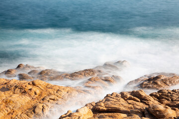 the sea crashing against the rocks