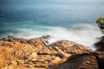 the sea crashing against the rocks
