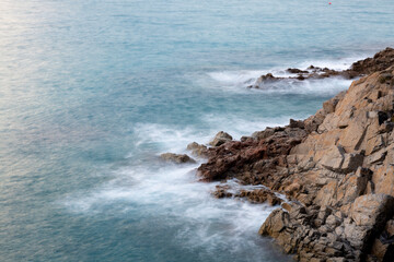 the sea crashing against the rocks