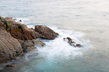 the sea crashing against the rocks
