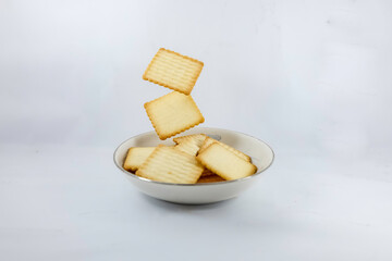 Cracker biscuits on white background. A cracker is a flat, dry baked food typically made with flour.