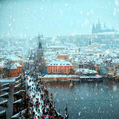 Fototapeta premium Prague at winter time, snow at Charles Bridge