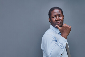 young african american man surprised showing fingers up on gray background