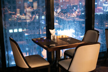 table with a rainy window view.