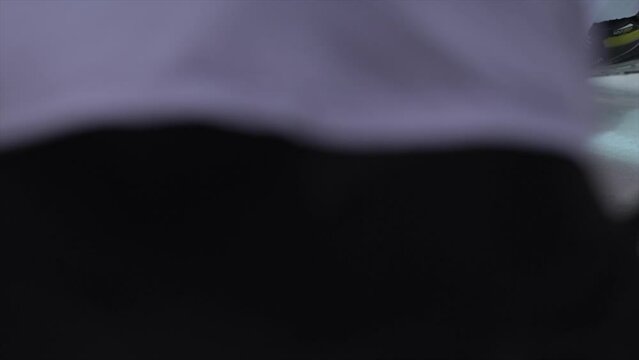 Ice Hockey cinematic slow motion footage of hockey players face off puck. Player Hitting Puck with stick at face off. Stylish Cinematic Close-up, Dramatic Lighting, 1000 fps Slow Motion Shot