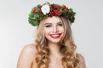 Naklejka premium Cheerful blonde woman portrait. Fashion female model with blond curly hairstyle, make-up and green and red winter accessories posing on white background