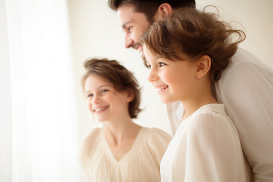 Side View Portrait of Parents and child lined up with a smile and a textured white background