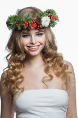 Naklejka premium model woman with long wavy hair, makeup and colorful natural winter decoration on white studio wall background, fashion beauty portrait