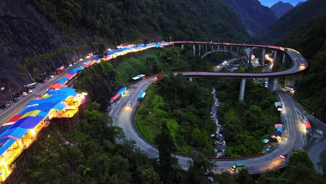 Aerial 4k video of Kelok 9 bridge at night. A popular bridge in Sumatra to commute between cities.