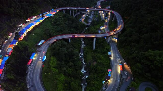 Aerial 4k video of Kelok 9 bridge at night. A popular bridge in Sumatra to commute between cities.