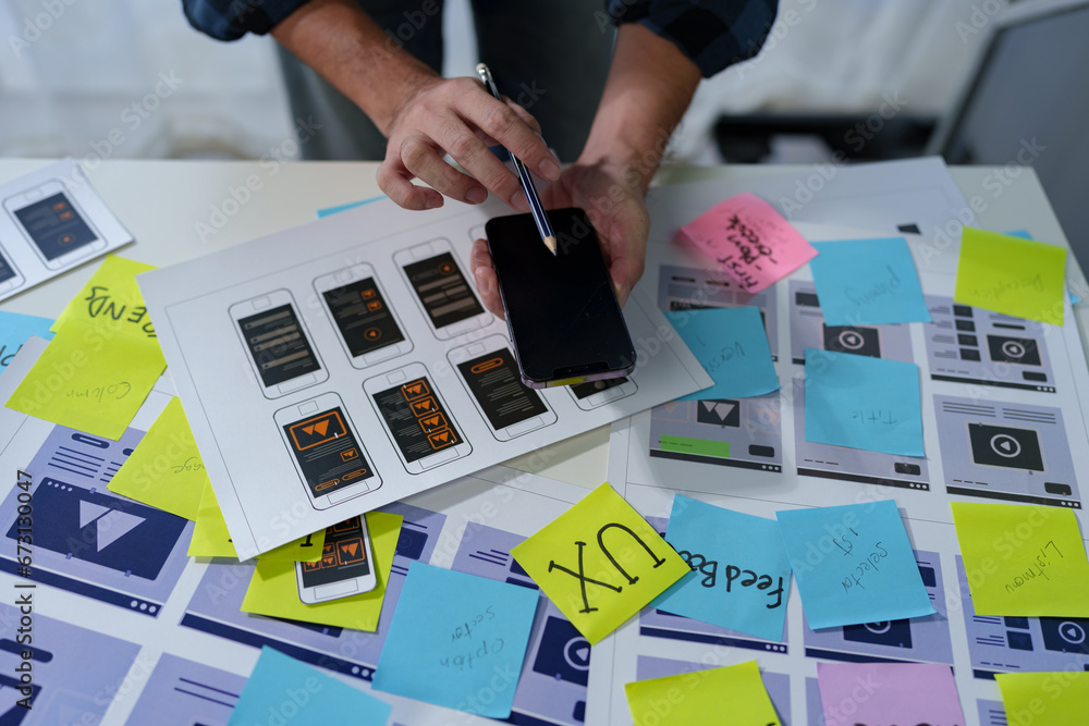 Wall mural developer, ui, ux designer, mobile app interface creation process, wireframe on the work desk for mo