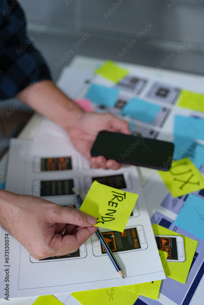 Wall mural developer, ui, ux designer, mobile app interface creation process, wireframe on the work desk for mo