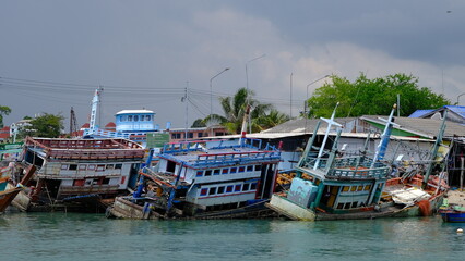 Old fishing boats wrecked at Ban Phe pier.