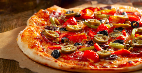 Tasty fresh backed pizza with tomatoes, olives, and pepperoni.