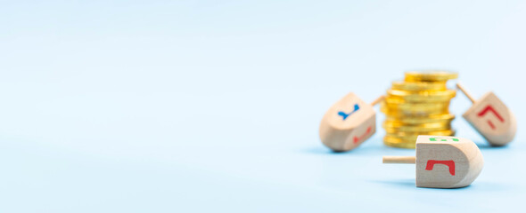 Jewish holiday Hanukkah concept. Traditional wooden dreidel - spinning top and chocolate coins gift.