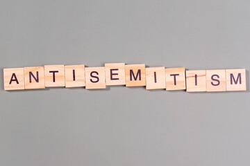 Antisemitism minimalistic concept. Isolated wooden letter blocks with word cloud Antisemitism. 