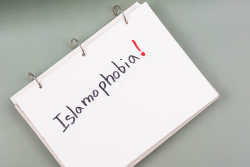 Islamophobia minimalistic concept. Word Islamophobia written on white paper with Exclamation point.