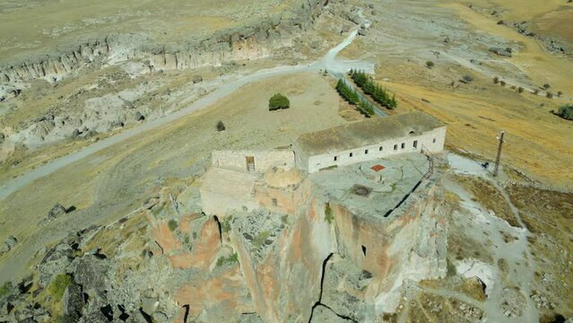 Aerial view of ancient Analipsis church in Aksaray - Turkey. The small complex is perched on a tall rock at the top of a long sloping hill and has a great view of the Mount Hasan in distance.
