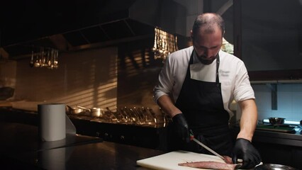 Italian Chef Cutting Fish For Second Course Wedding Food into kitchen