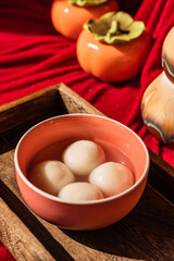 Chinese traditional festival delicacy sweet soup balls on a wooden tray