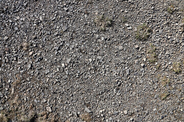 Background of shattered stony stones surface in mountain area. Flat texture with natural light