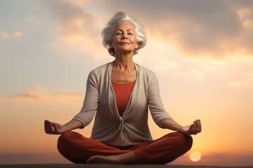 Fototapeta na wymiar Photo of a senior woman practicing meditation and mindfulness. Generative AI