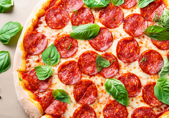 Pepperoni pizza garnished with basil leaves