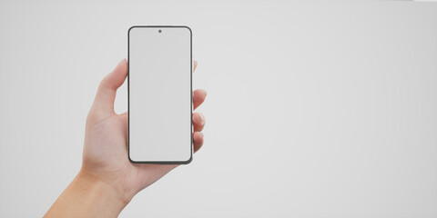 Caucasian woman holding phone on a white background, blank screen mockup