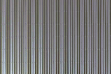 The texture of corrugated cardboard craft paper - grey. Grey corrugated cardboard useful as a background and texture.