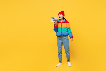Full body young woman she wears padded windbreaker jacket red hat casual clothes hold in hand megaphone scream announces discounts sale Hurry up isolated on plain yellow background. Lifestyle concept. - obrazy, fototapety, plakaty