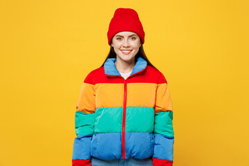Young smiling happy cheerful satisfied cool fun woman she wearing padded windbreaker jacket red hat casual clothes look camera isolated on plain yellow background studio portrait. Lifestyle concept. © ViDi Studio