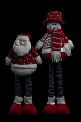 Muñecos de navidad de Papa Noel y un muñeco de nieve con piernas largas