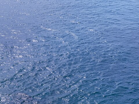 Blue sea water glittering surface.