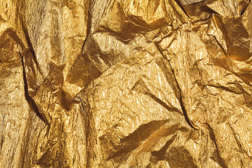 Abstract, Luxury concept. Shiny and sparkling golden background or texture with wrinkles and...