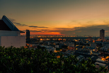 The high angle background of the city view with the secret light of the evening, blurring of night lights, showing the distribution of condominiums, dense homes in the capital community