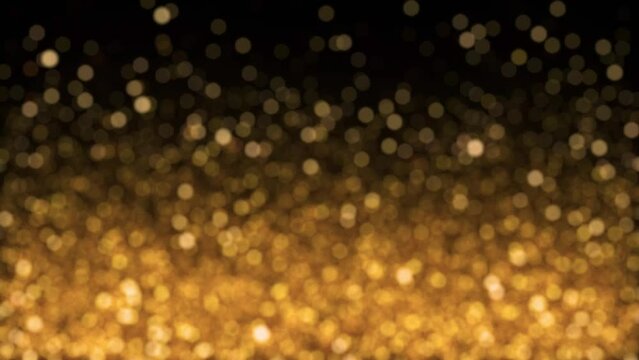 Looped animated Christmas background of luminous and blurry golden particles floating on black background