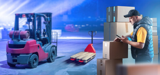Man storekeeper. Worker with boxes. Guy near forklift. Storekeeper is standing with telephone. Logistics company employee. Man loader near forklift. Career in logistics industry.