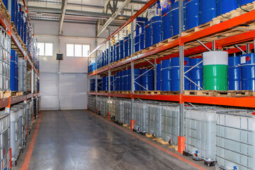Chemical factory warehouse. Storage with barrels on pallets. Warehouse racks in industrial...