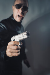 Black leather jacket hitman spy with gun