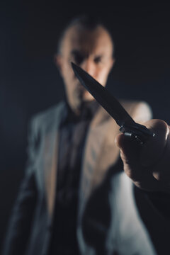 Assassin murderer killer holding knife weapon