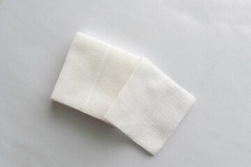 pair of foled gauze pads on white background.