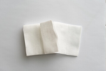 pair of foled gauze pads on white background.