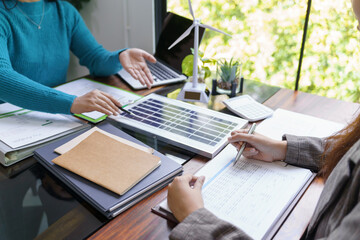 Solar panels green energy Business people working in green eco friendly office business meeting...