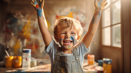 A delighted little boy, radiating extreme happiness after his art painting class, with paint adorning his hands and face