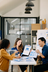 Team business people meeting in office. Employee brainstorm and work plan and discuss project by point on paper and tablet. .