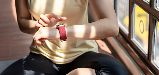 Woman workout with health app on smart watch Close-up hands